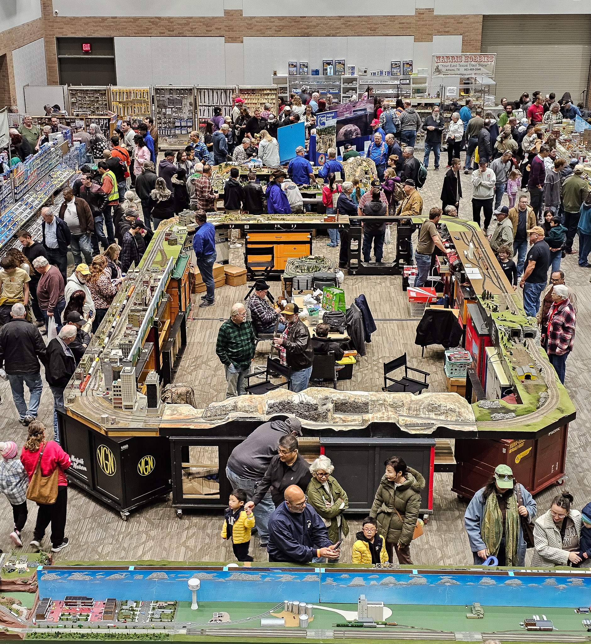 Overview of the DFW Train Shows with a large crowd viewing model train layouts in Plano, TX.